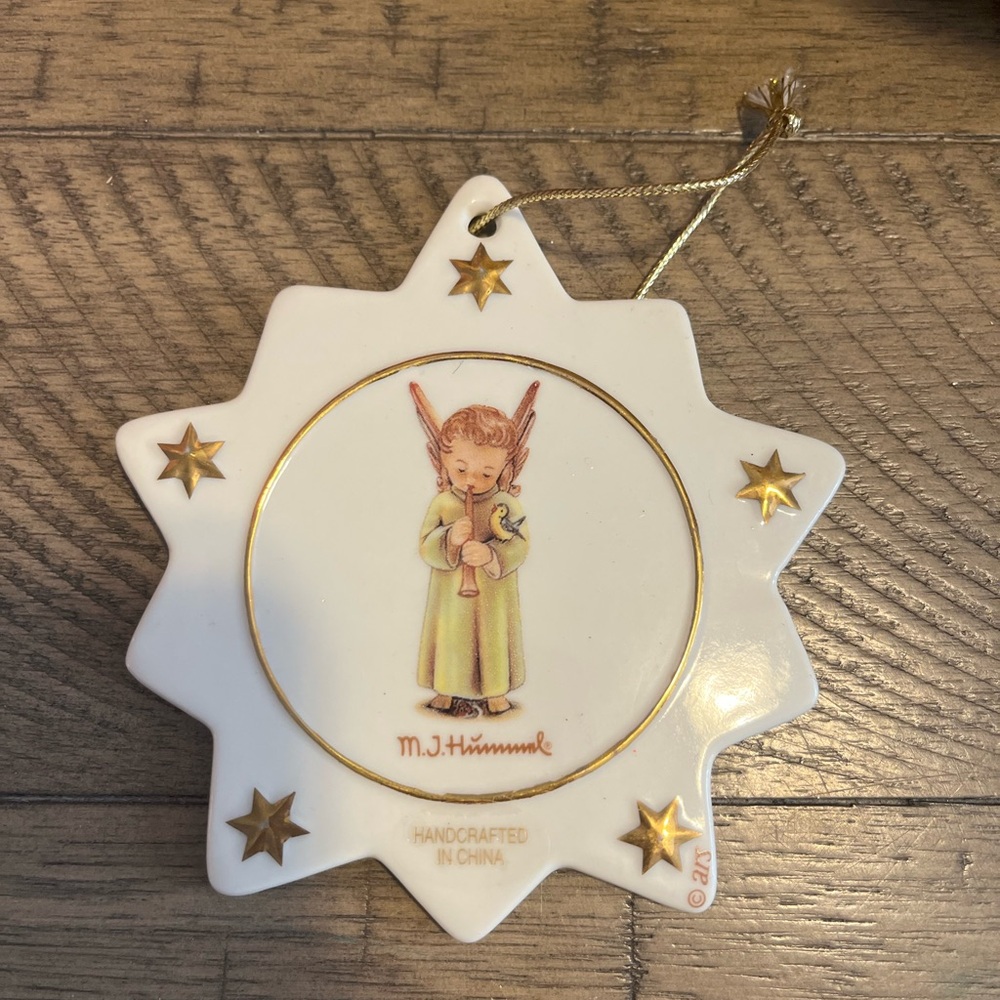 M.J. Hummel star-shaped Christmas ornament featuring an angel playing a flute